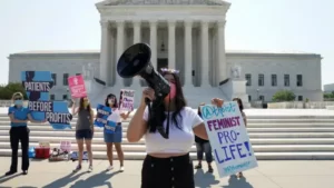 Pro life demonstrators hold signs in front of the US Supremem Court as Roe v Wade is overturned