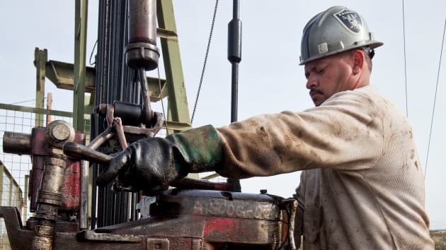 A floorhand operates a Chevron oil drilling rig near Taft California