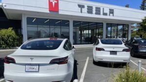 Brand new Tesla cars sit in parking lot of Tesla showroom