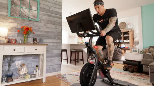 Brody Longo works out on his Peloton exercise bike on April 16, 2021 in Brick, New Jersey.