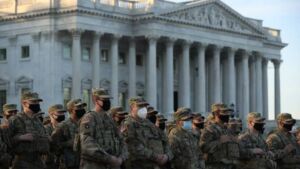 National Guard troops pose for photograph the day after vote to impeach Donald Trump