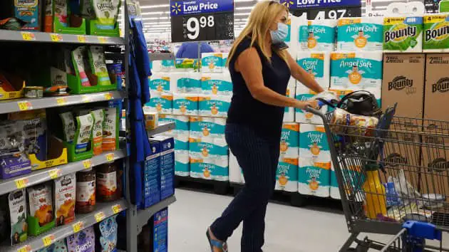 A shopper wearing a protective mask shops in a Walmart store